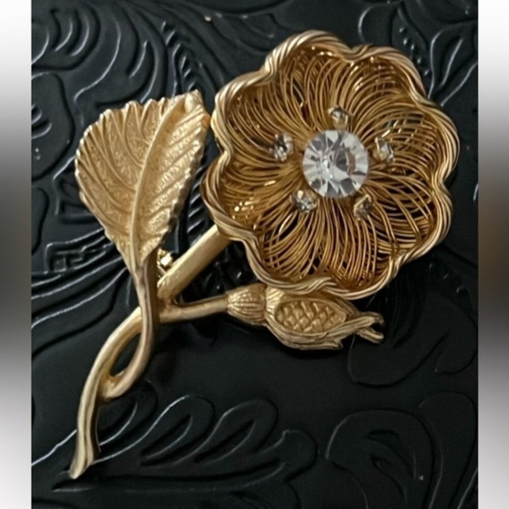 Elegant Gold Floral Brooch with Crystal Accents